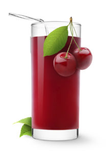 Glass of sweet cherry juice isolated on white